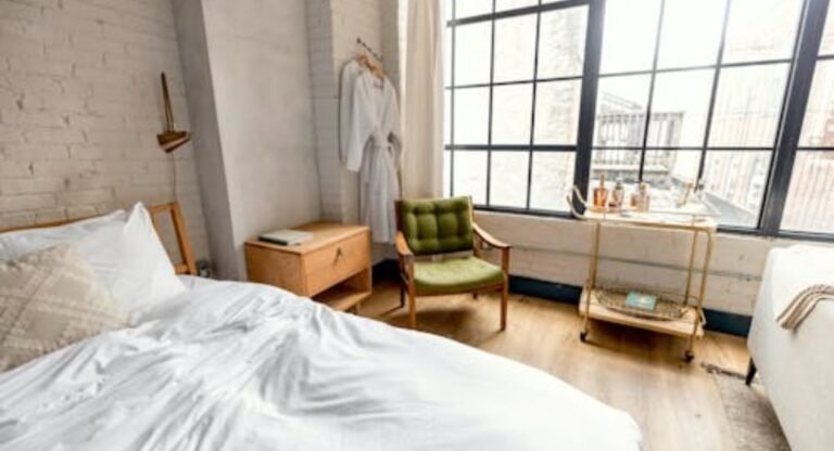 Minimalist futon bedroom design with soft beige decor and natural window light