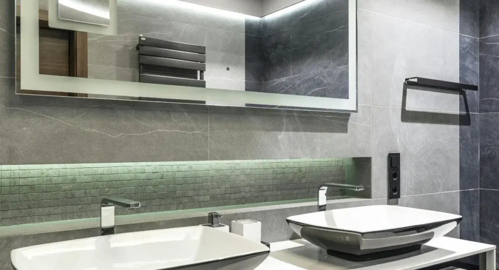 Modern black bathroom lighting with pendant lights over vanity and warm dimmable glow in a luxury contemporary bathroom.