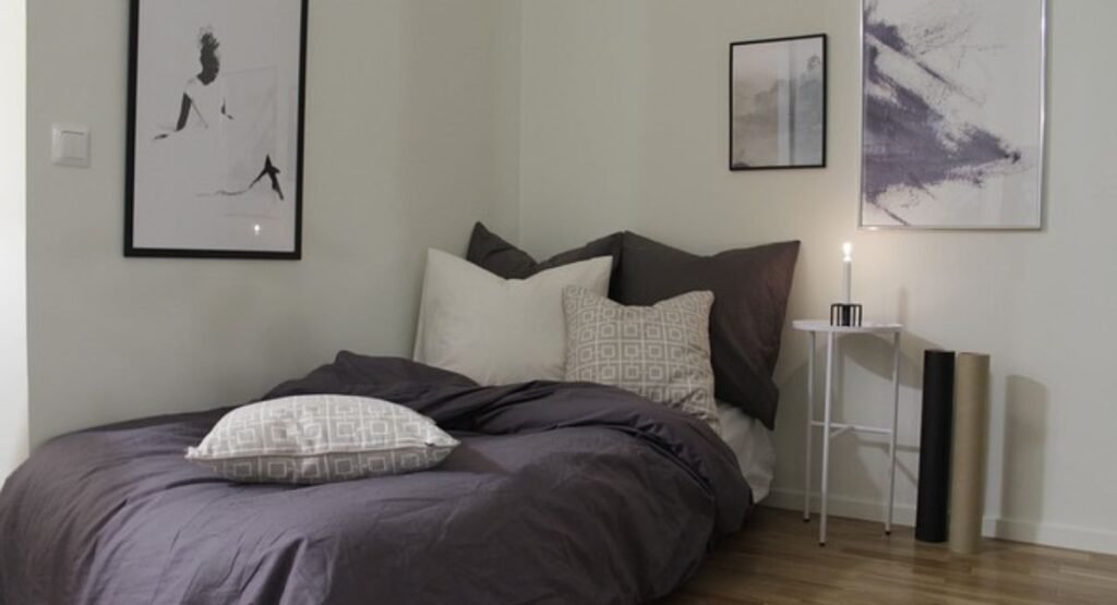 Coastal bedroom textures: linen bedding, rattan cane, jute rug weave, and driftwood-style wood finishes