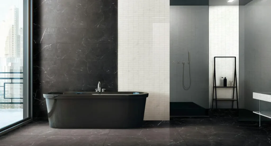 Freestanding matte black bathtub in a luxury bathroom with dramatic lighting and marble floor, creating a spa-like atmosphere.