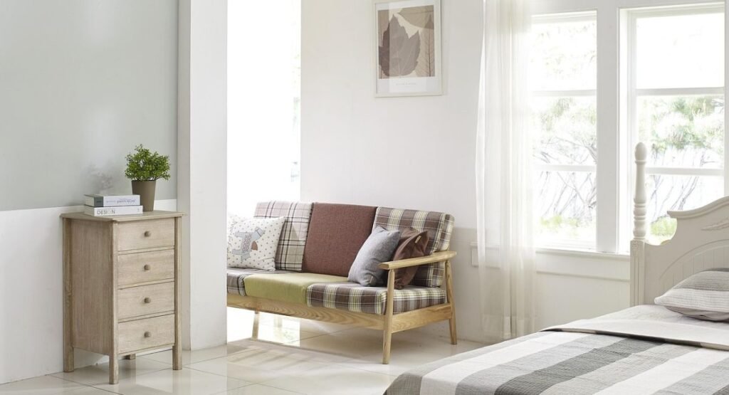 Modern small futon bedroom with low bed and built-in wall shelves for organized storage