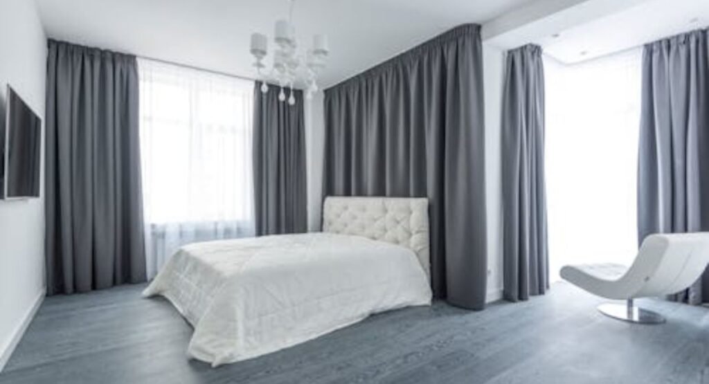 Small modern futon bedroom with minimalist decor and sheer curtains
