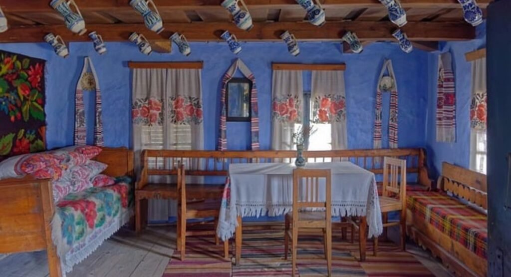 Beach themed bedroom ideas: properly sized jute rug, linen curtains hung high, coastal wall art, subtle stripes, and woven baskets