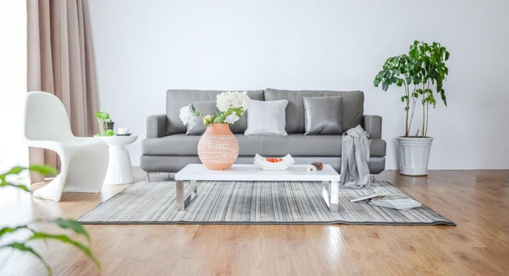 Moody small futon bedroom with dark green walls, low bed, warm bedside lamp, and cozy textured bedding