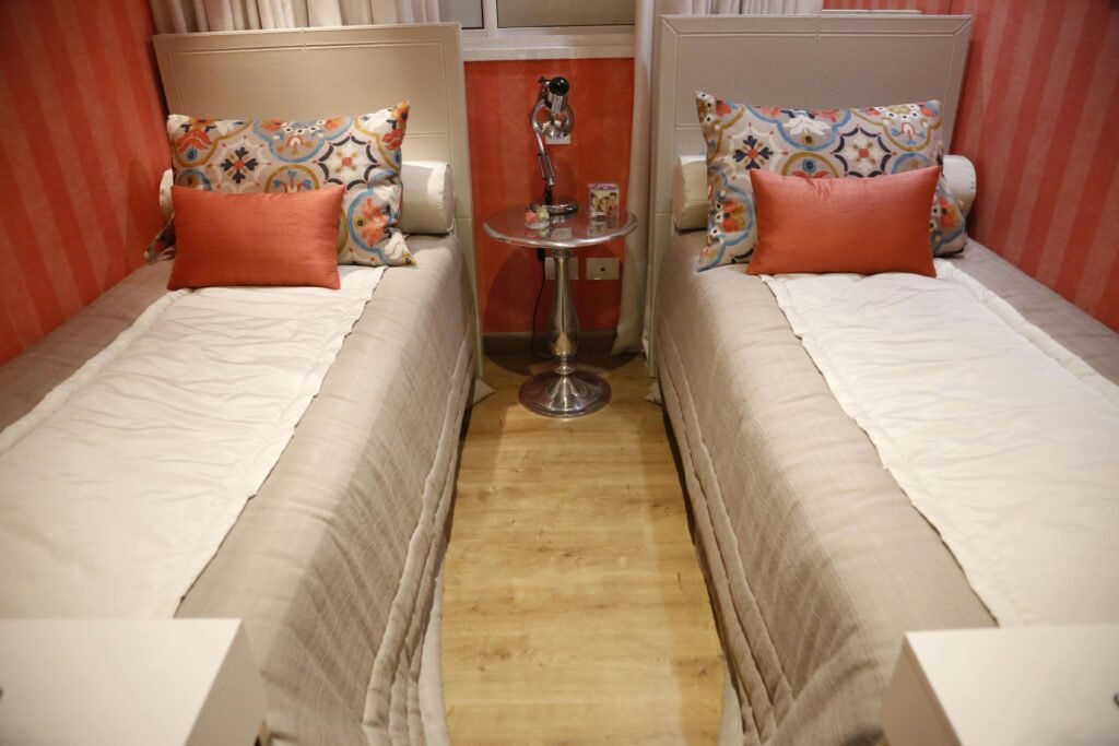 stylish twin bedroom with mixed textures, modern bunk beds, and statement ceiling lighting