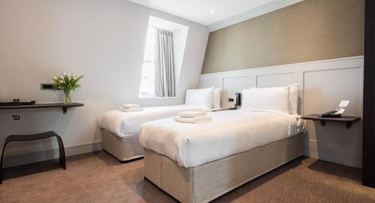 Stylish twin bedroom ideas with two beds, cozy bedding, neutral decor, and warm lighting creating a luxurious and comfortable shared bedroom design