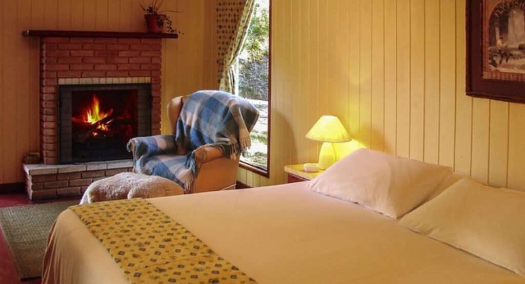 What to buy first for a beach themed bedroom: white textured bedding, linen curtains, jute rug, bedside lamps, coastal wall art, woven baskets